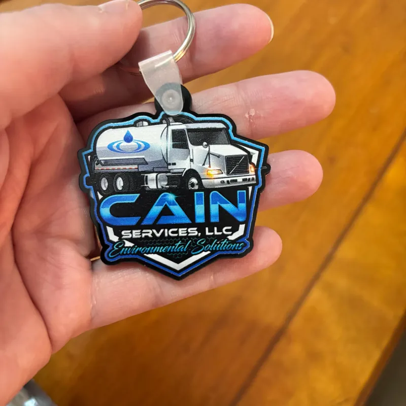 Cain Services LLC business logo keychain on black contour-cut acrylic