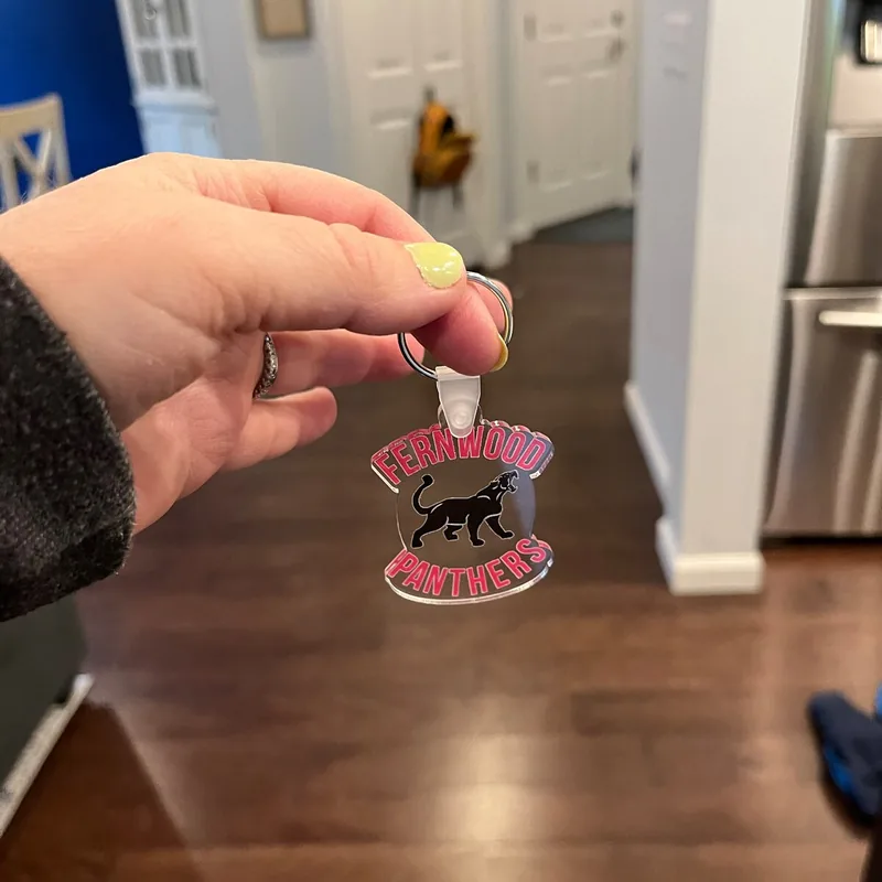 Fernwood Panthers school spirit keychain held in hand