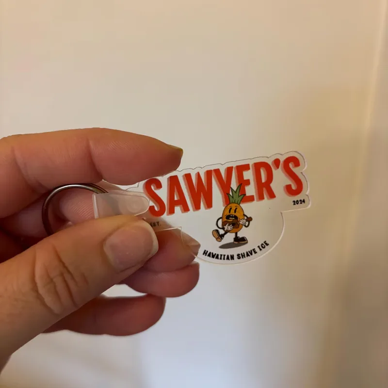 Contour-cut Sawyer's Hawaiian Shave Ice logo keychain on clear acrylic