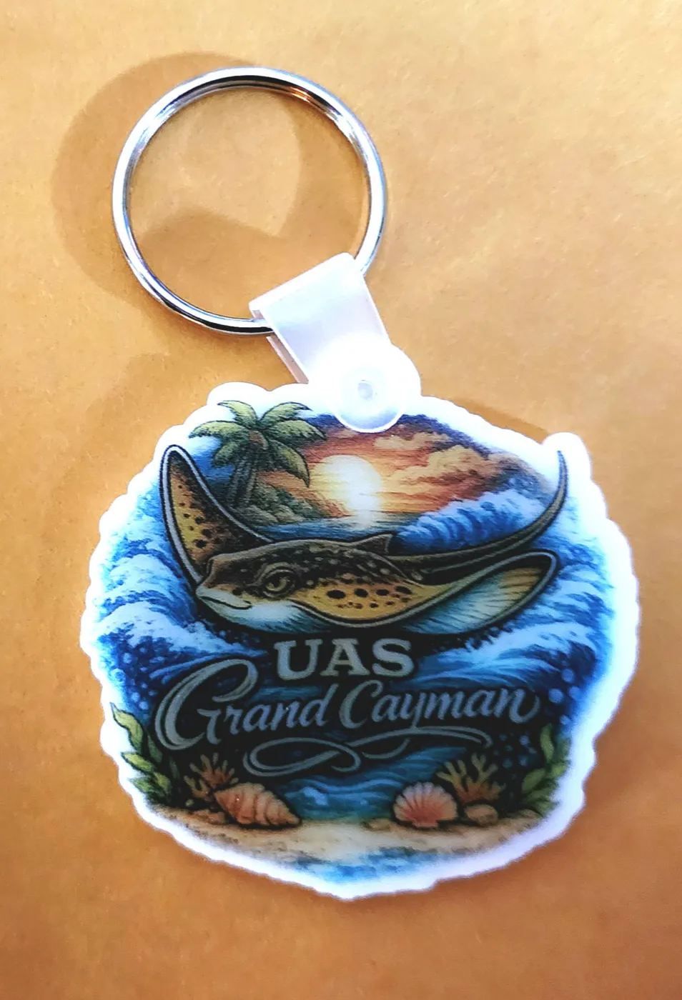 Full-color stingray and beach scene keychain cut to its own shape